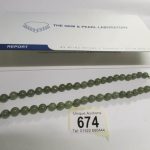 A C jadeite jade necklace of 49 slightly graduated round polished stones
