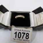 A five stone half band diamond eternity ring in yellow gold