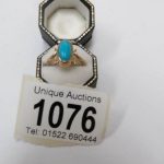 A turquoise cabachon gold ring