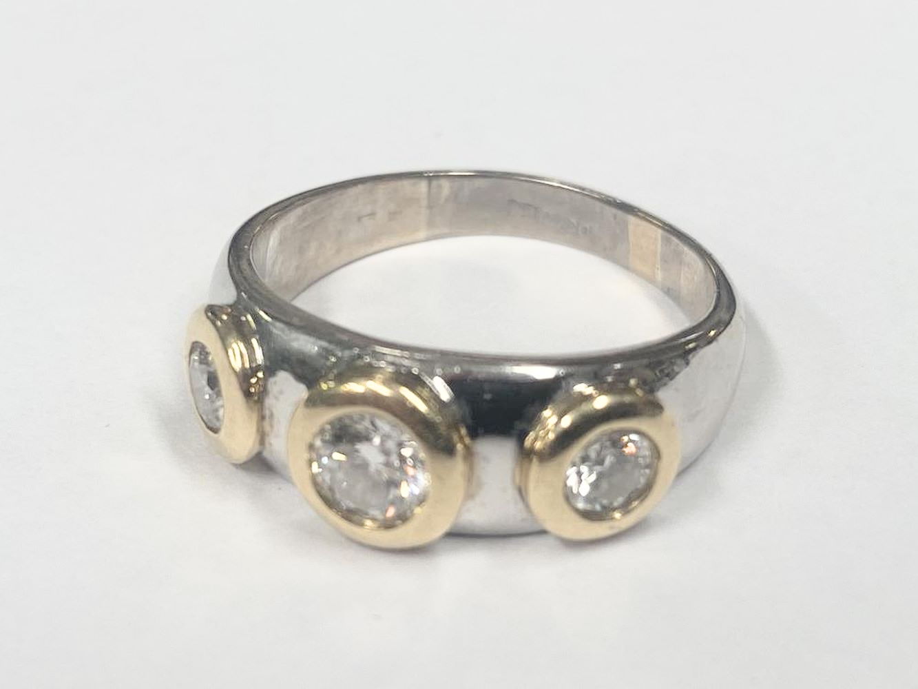 An 18ct yellow & white gold ring set round brilliant cut diamonds